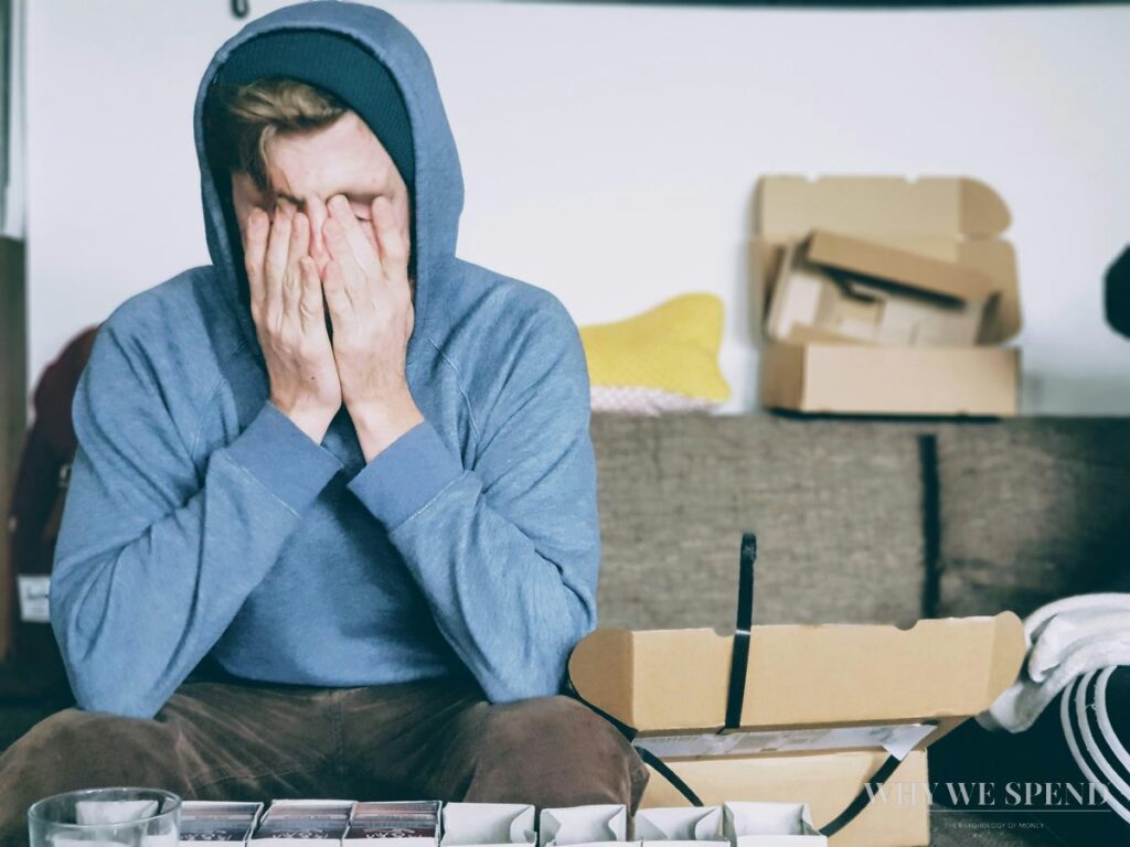 Man stressed surrounded by delivery boxes — payday spending regret