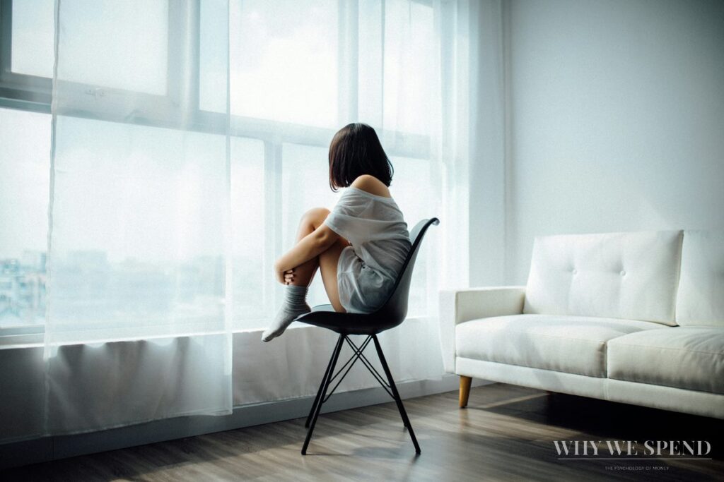 Woman sitting alone reflecting — feeling financially stuck despite earning well