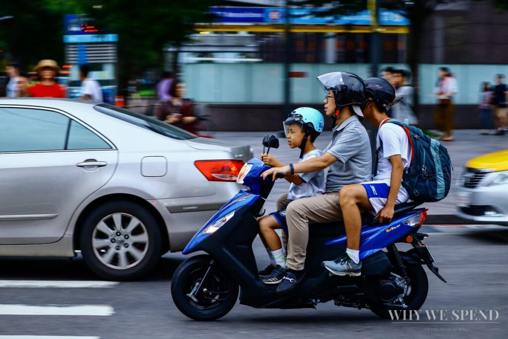 Southeast Asian family on motorbike — inherited money mindset from childhood