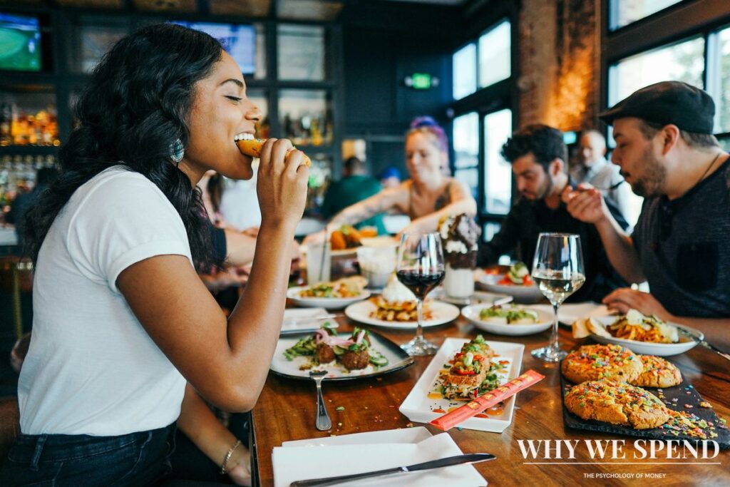 Group of friends calculating and splitting dinner bill together