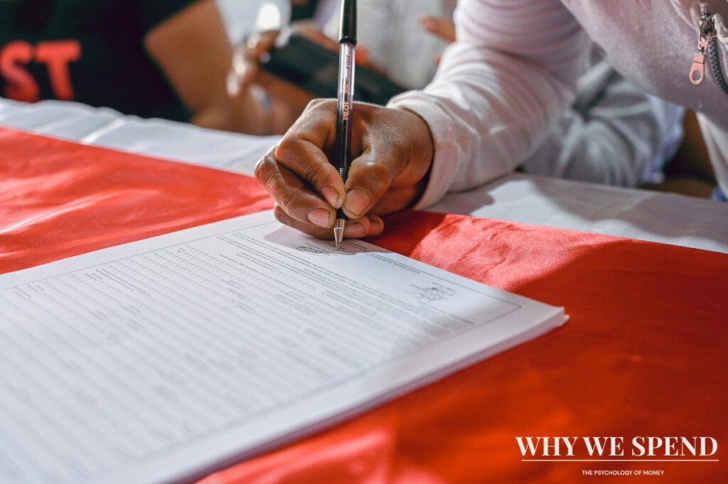 Person confidently signing important documents at desk