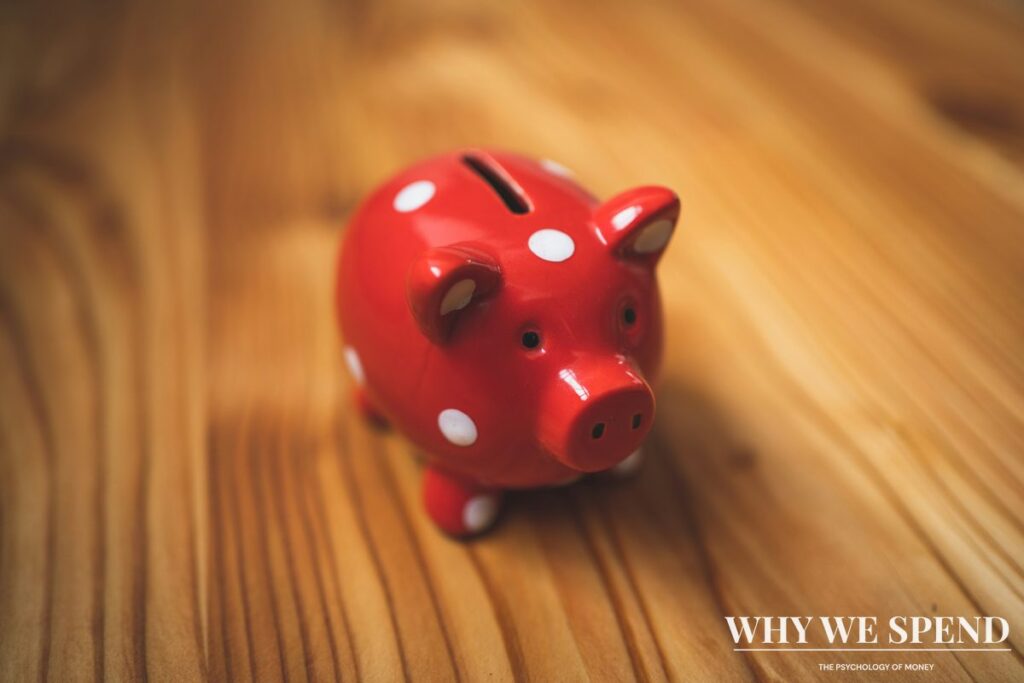 Traditional piggy bank overflowing with coins representing excessive cash hoarding behaviour