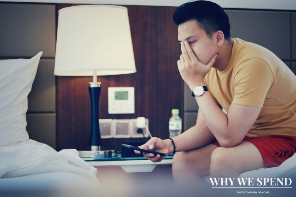 Person avoiding looking at financial documents or mobile banking app