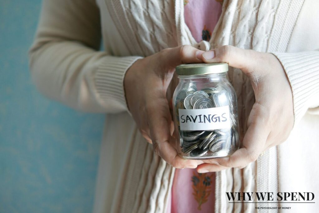 Simple savings jar filled with coins, representing a minimalist approach to setting money aside.