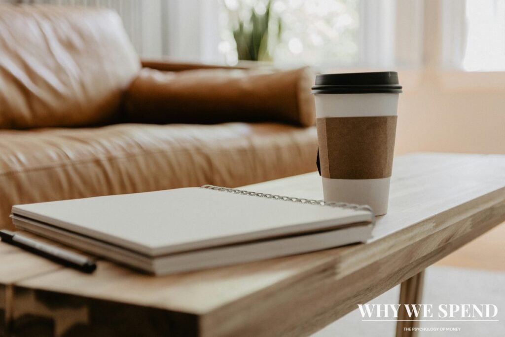 Budget planning notebook with coffee showing intentional financial planning