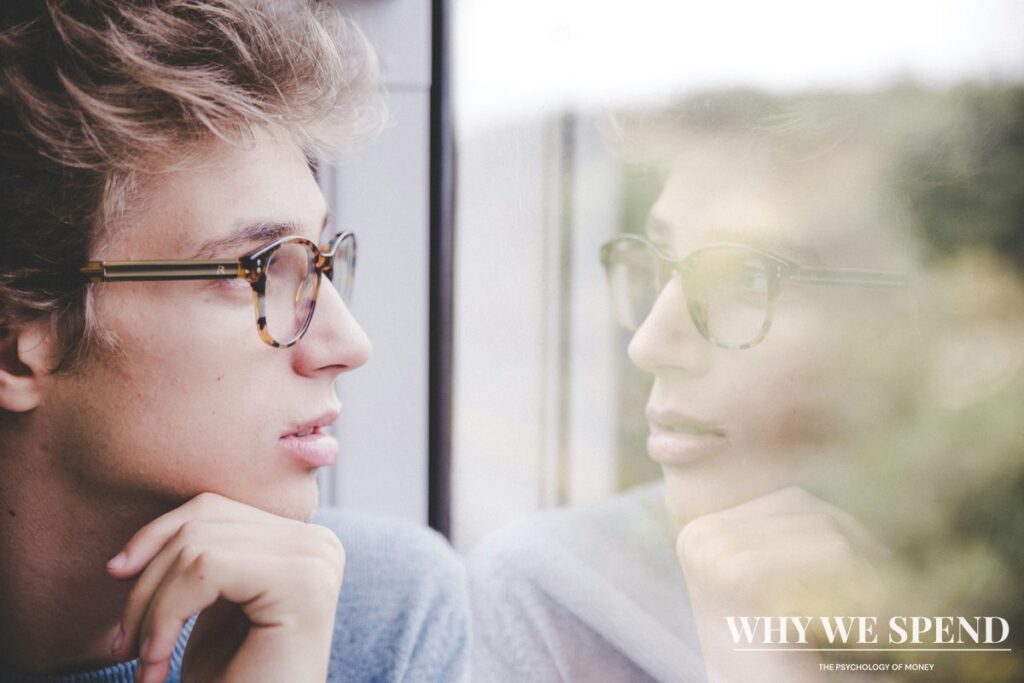 Person examining reflection symbolising identity and self-concept