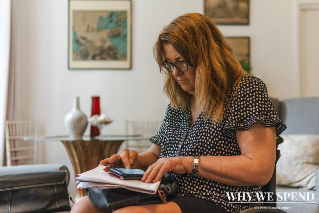 Person looking stressed while reviewing bills and household expenses