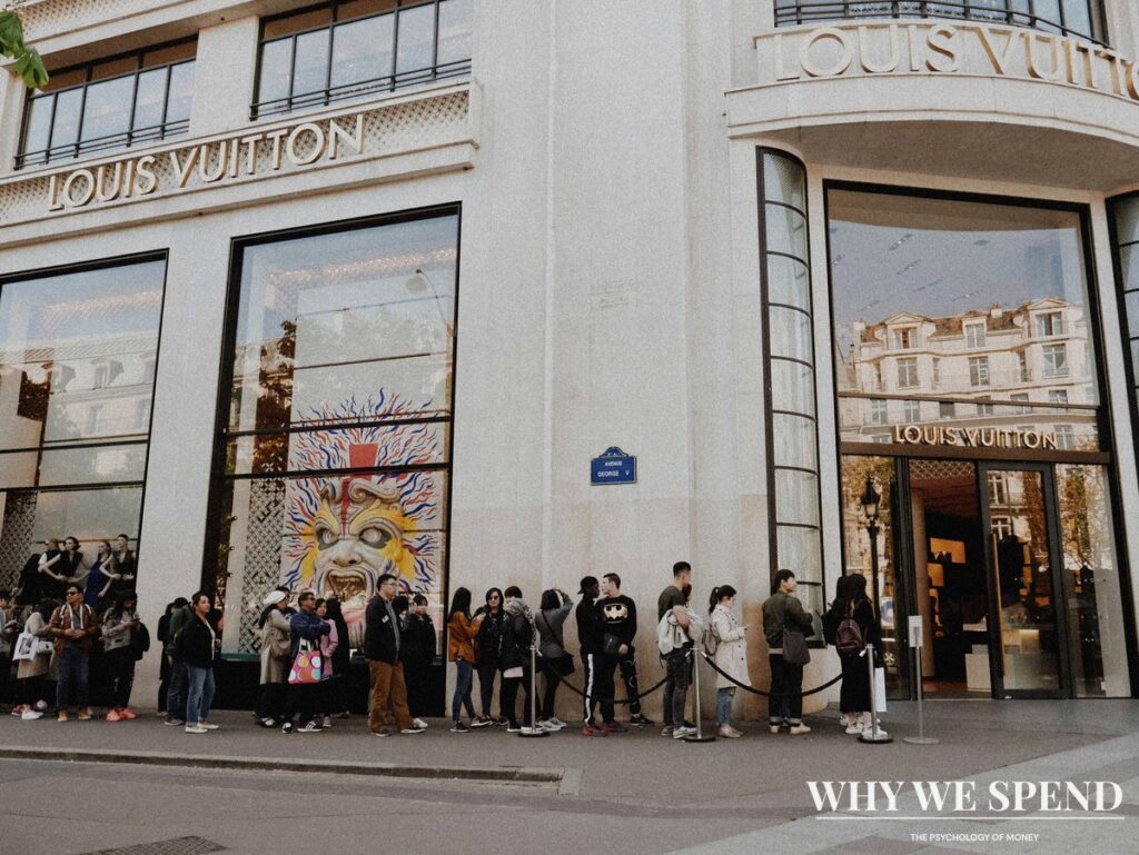 Shoppers queuing outside luxury retail boutique during sale