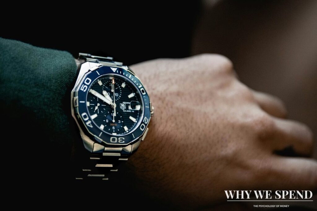 Person wearing expensive designer watch as status symbol