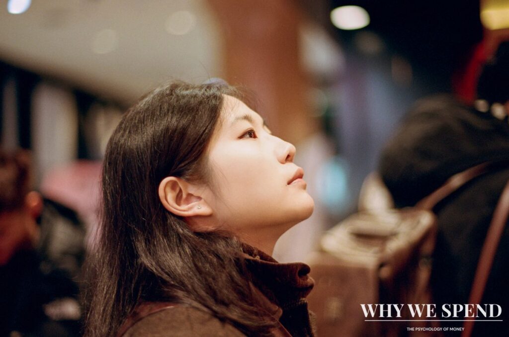 Young Asian woman contemplating purchase decision in store