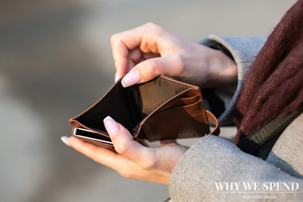 Person looking worried while checking empty wallet representing overspending during stable times