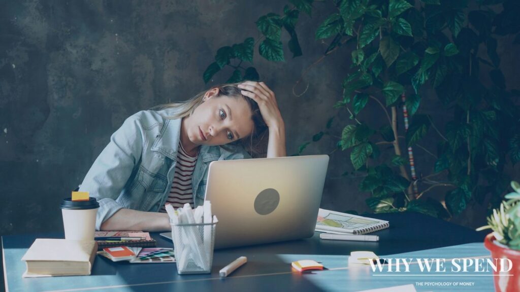 Person looking stressed while reviewing financial documents and bills