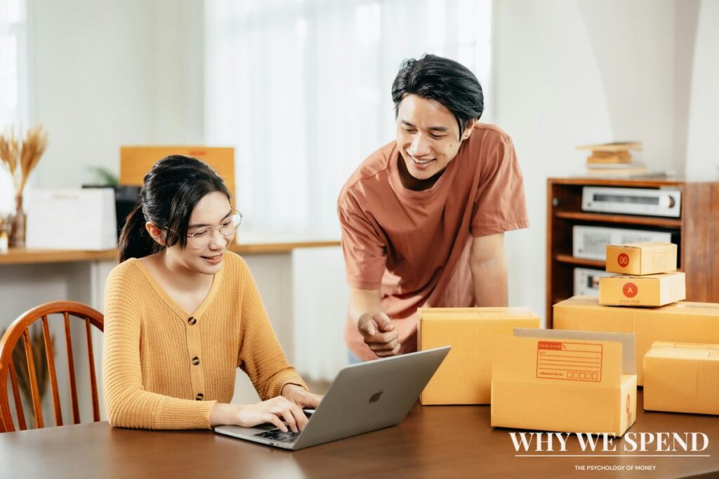 Person shopping online with delivery boxes nearby