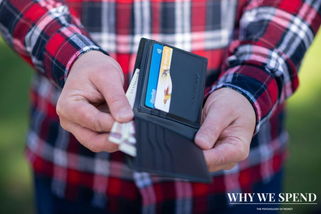 Person holding credit cards with worried expression showing financial stress