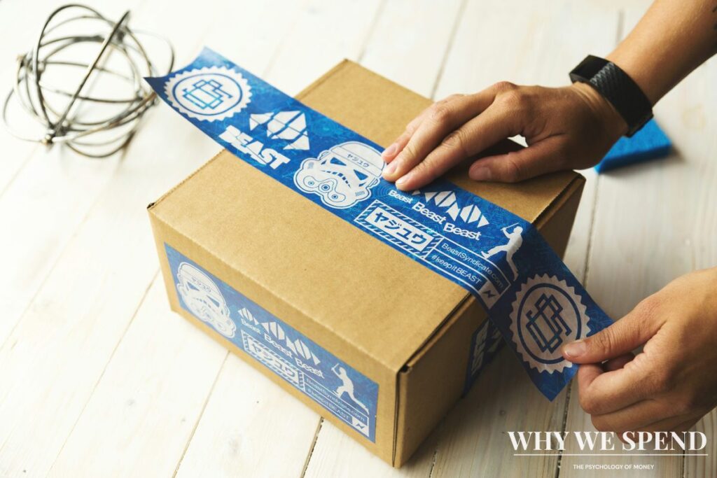 Person packing items for return in shipping box