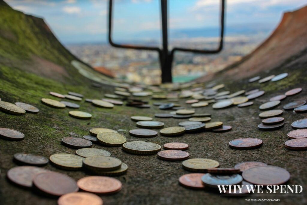 Money being poured down a drain representing the sunk cost fallacy