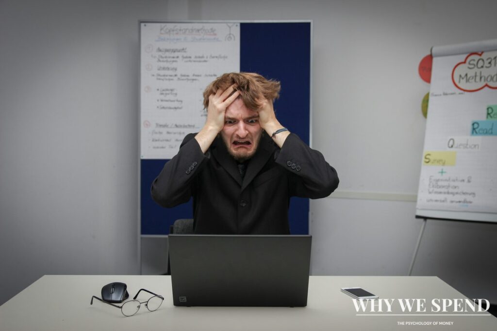 Person looking frustrated while reviewing financial documents and making decisions