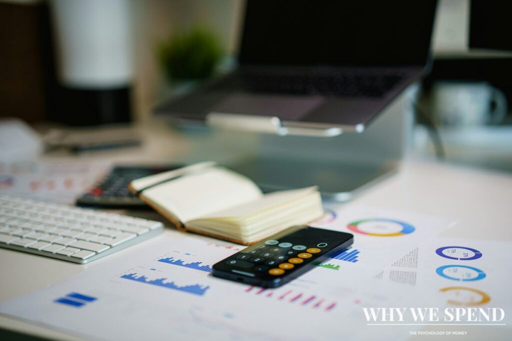 Calculator and notebook with budget planning spreadsheet showing financial discipline