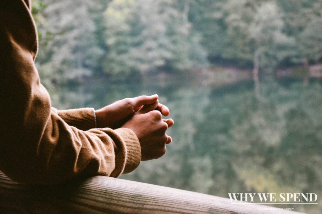 Person in thoughtful pose representing self-awareness about financial biases