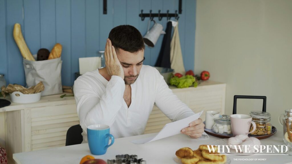 Person reviewing bills and financial statements with concerned expression