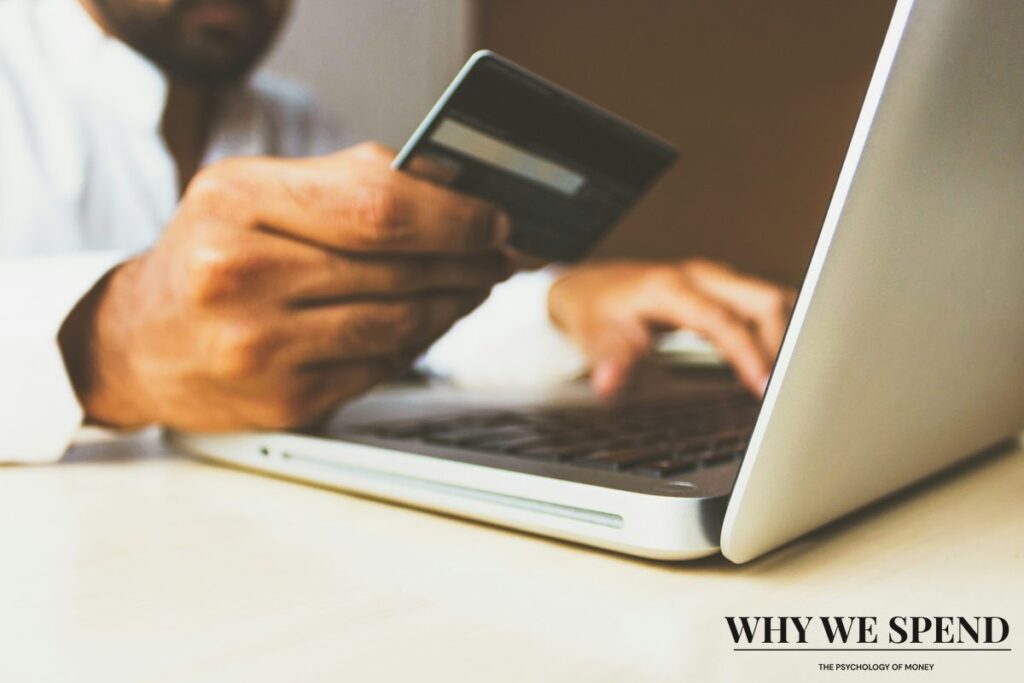 Hand entering credit card details for online subscription purchase
