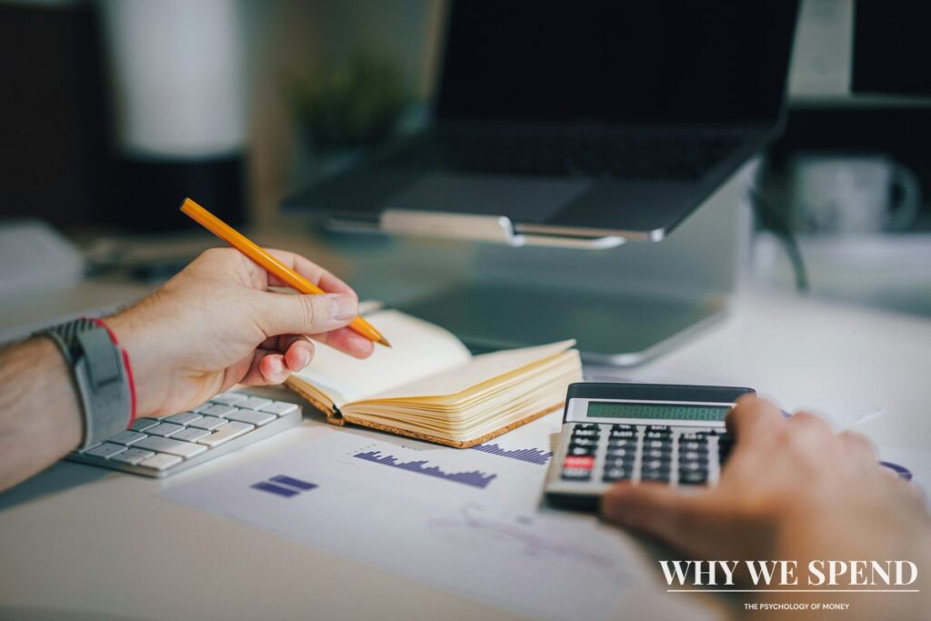 Person calculating monthly subscription costs on calculator and spreadsheet
