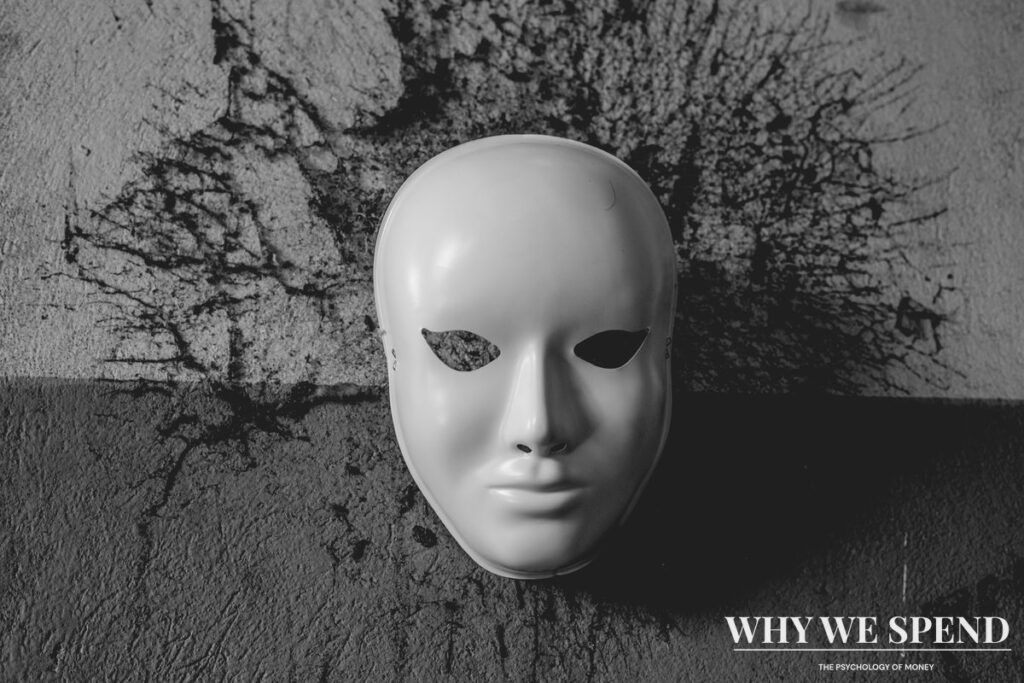 Conceptual image of mask representing hiding financial struggles behind false appearances