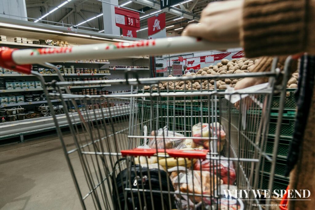 Full shopping trolley in supermarket aisle during panic buying before bad weather