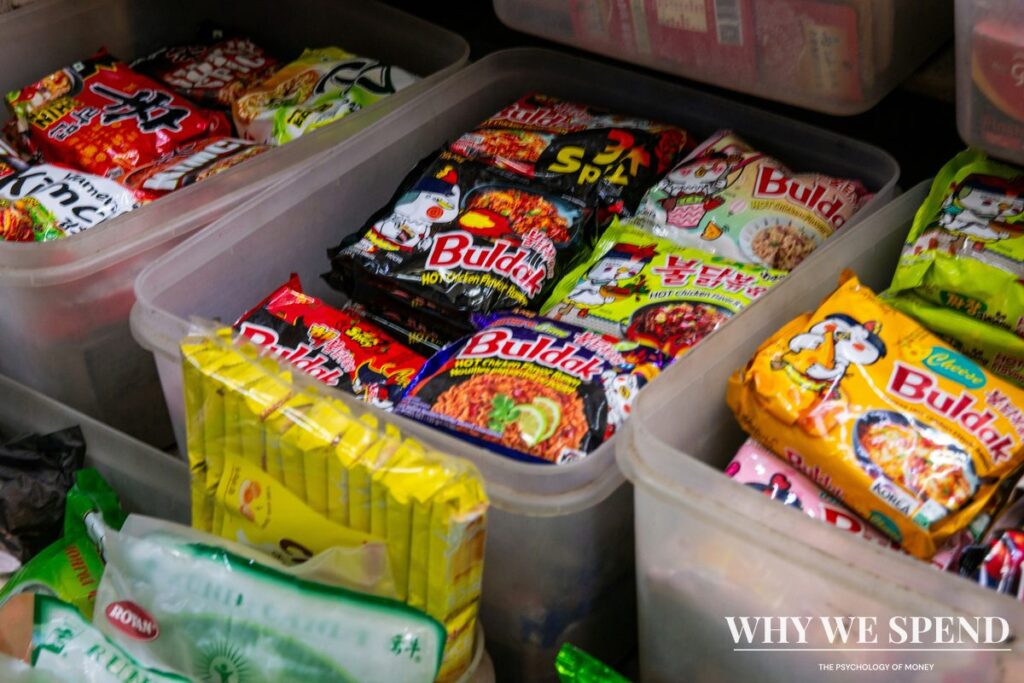 Overstocked pantry shelves filled with instant noodles and tinned goods from panic buying
