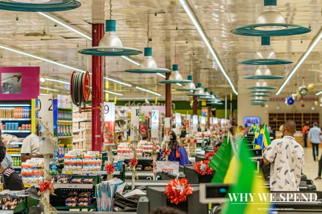 Crowded supermarket aisle with shoppers filling trolleys during panic buying