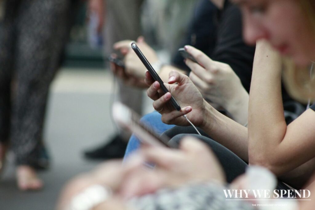 Person scrolling through social media on phone looking anxious