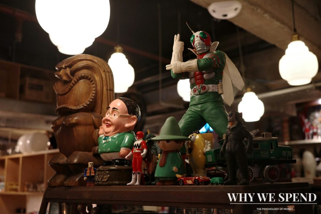 Curated display of vintage collectibles on illuminated shelves representing collecting psychology
