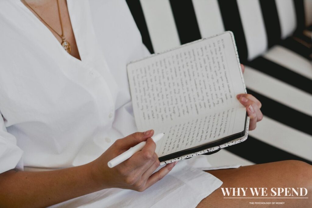 Person writing in journal practicing mindful reflection and planning