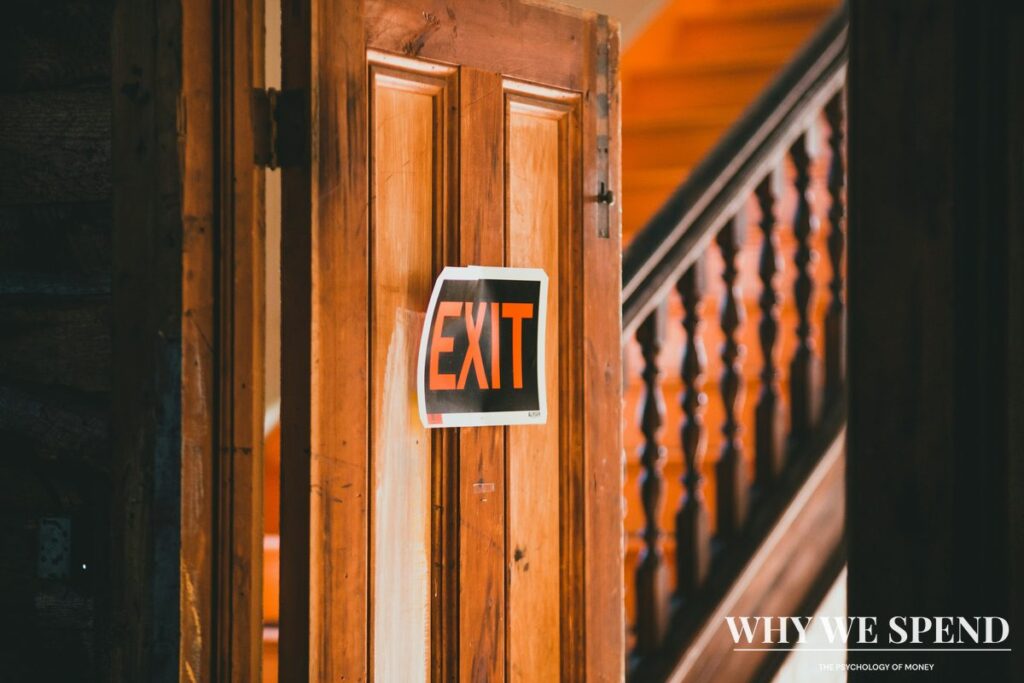 Person walking towards exit door leaving building
