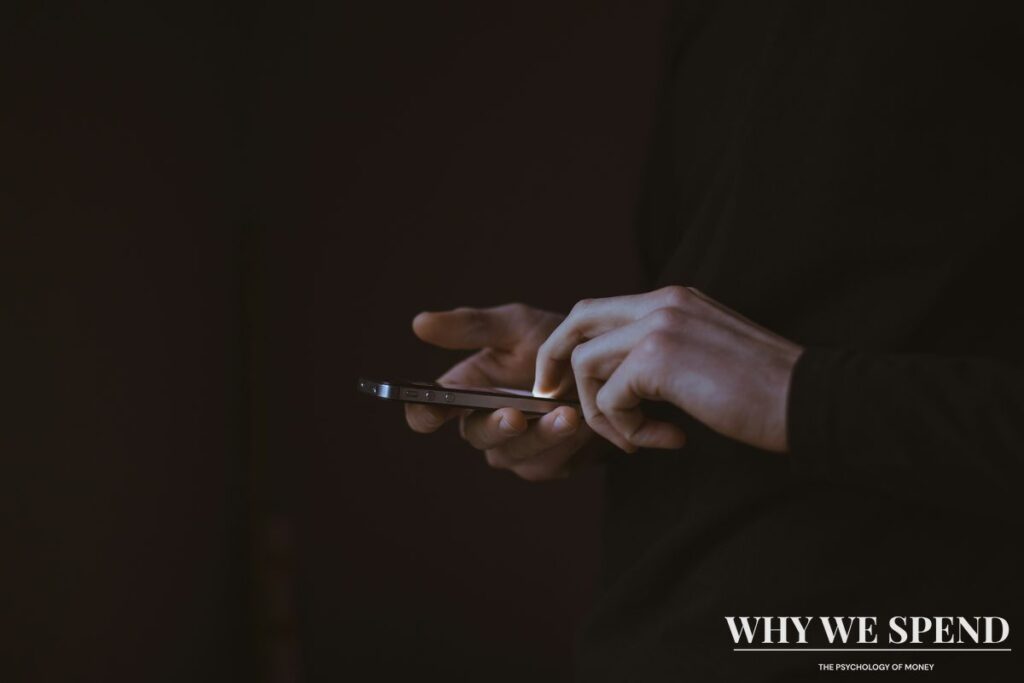 Person scrolling through conflict news on smartphone triggering financial anxiety