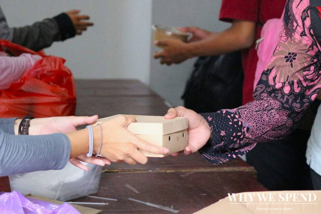 Hands exchanging donation illustrating matched giving psychology