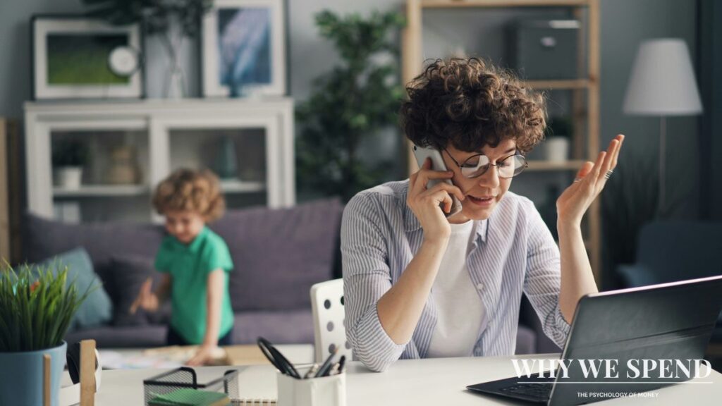 Working parent looking stressed while checking time on laptop