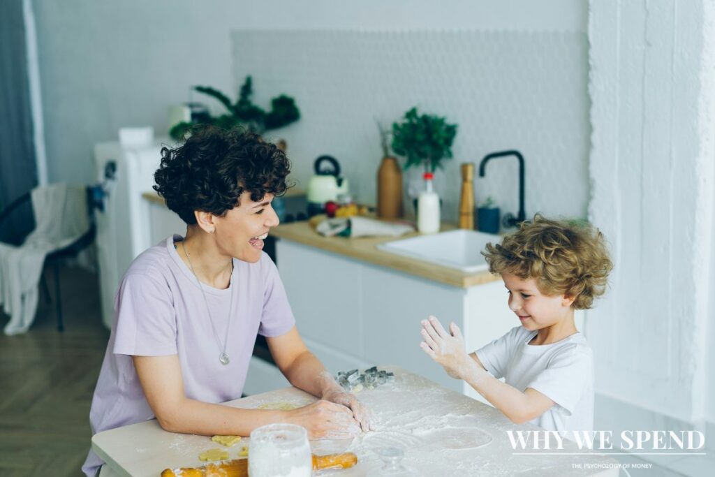 Parent and child cooking together in home kitchen, smiling