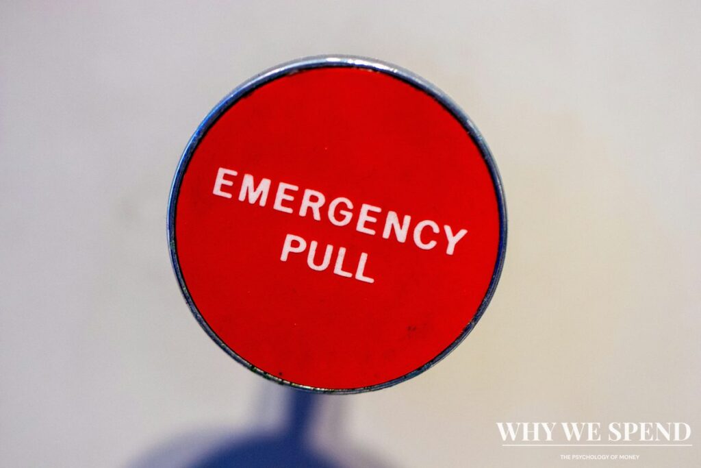 Red fire alarm on wall symbolising financial crisis warning signs