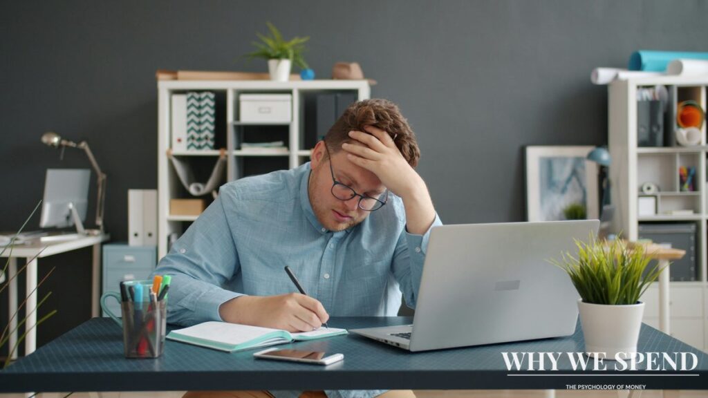 Person looking anxiously at financial documents and bills on laptop screen